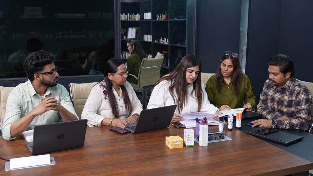 Founder reviewing skincare products with development team